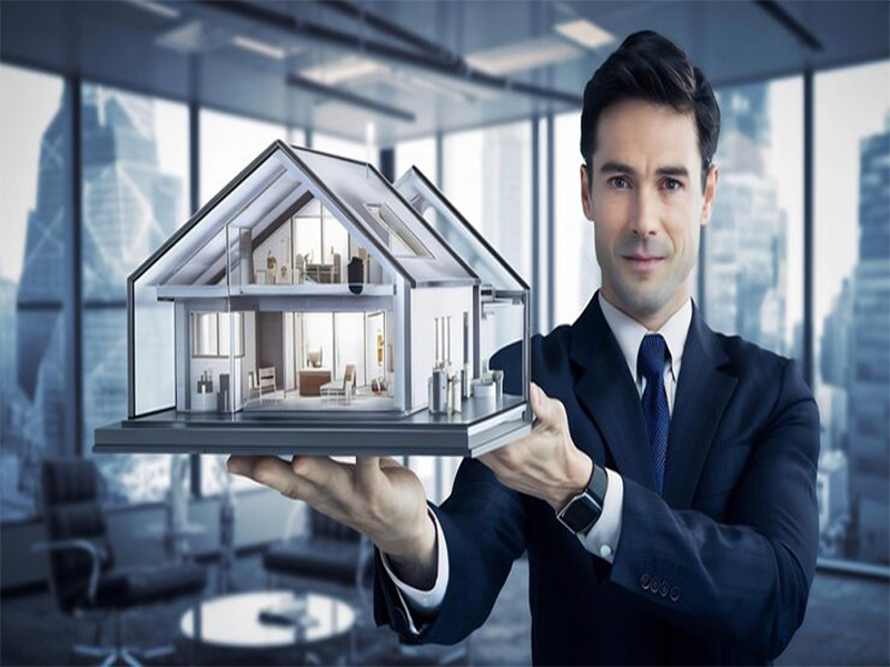 Businessman Holding Model House